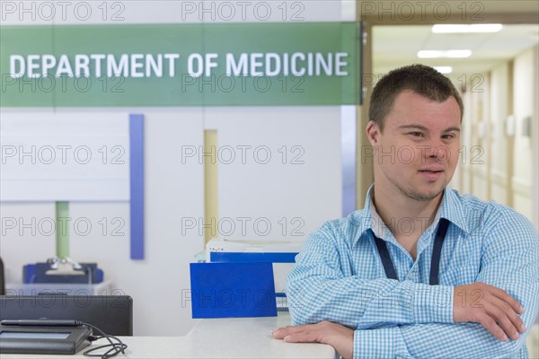 Caucasian man with Down Syndrome working in hospital