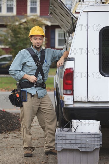 Caucasian worker smiling at truck