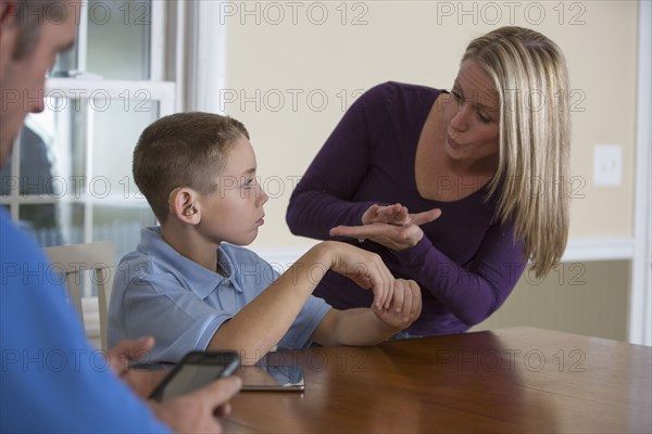 Caucasian mother signing with deaf son