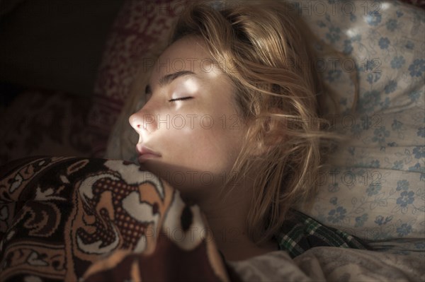 Caucasian woman sleeping in bed