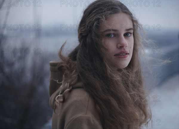 Portrait of wind blowing hair of serious Caucasian teenage girl