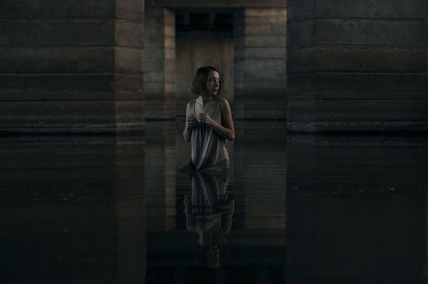 Caucasian woman standing waist deep in water
