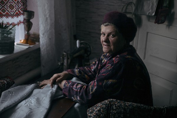Older Caucasian woman using sewing machine