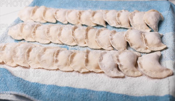 Rows of pierogies on towel