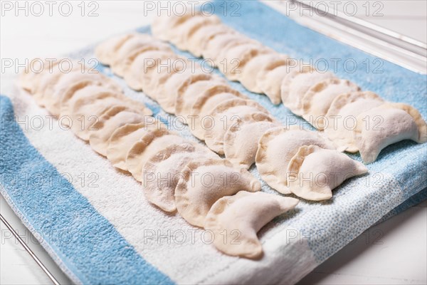 Rows of pierogies on towel