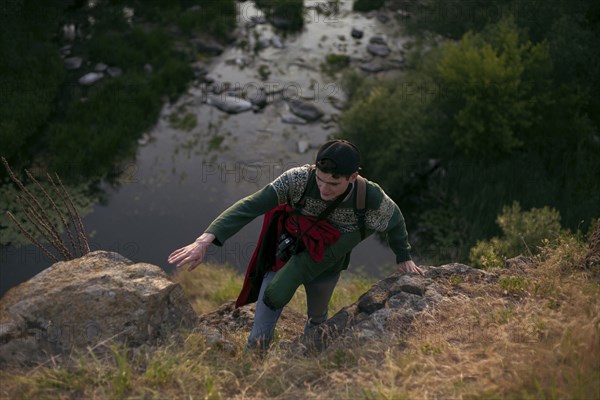 Caucasian man hiking near river