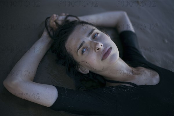 Caucasian woman laying on beach