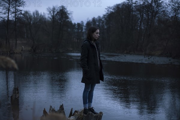 Caucasian woman standing near river