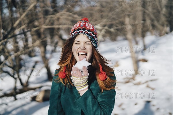 Caucasian woman licking snow