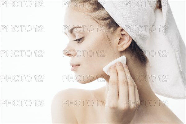 Caucasian woman cleaning chin with pad