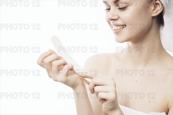 Caucasian woman filing nails