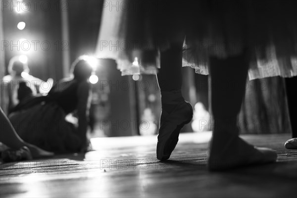 Legs of woman wearing ballet shoes