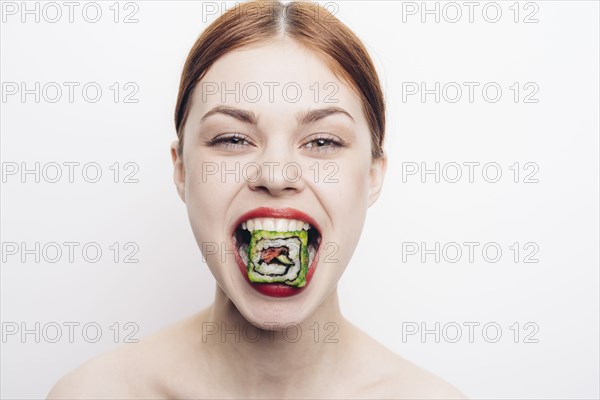 Caucasian woman with mouthful of sushi