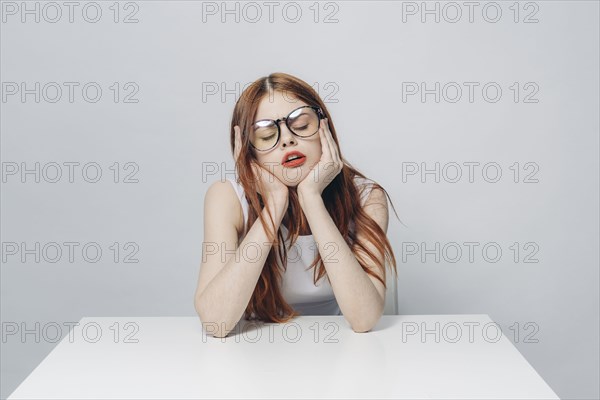 Frustrated Caucasian woman sitting at table