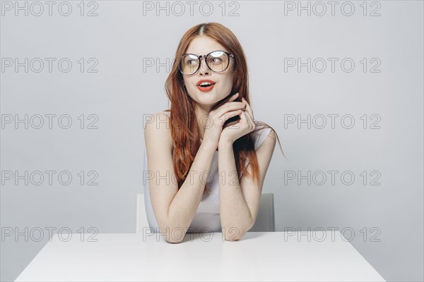 Happy Caucasian woman sitting at table