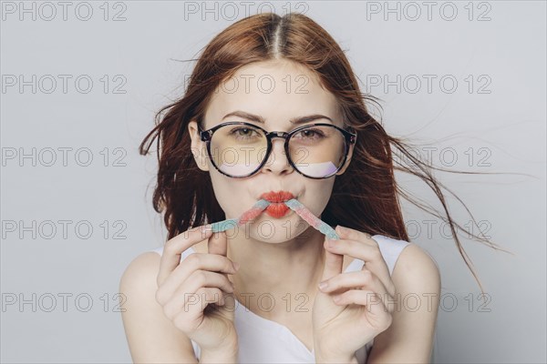 Caucasian woman eating candy in wind