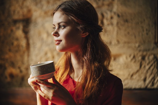 Caucasian woman holding cup of tea