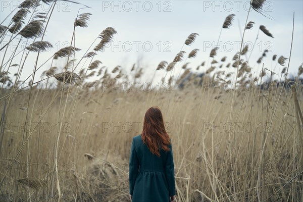 Rear view of Caucasian woman standing in field