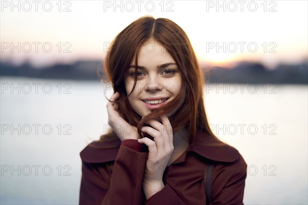 Portrait of smiling Caucasian woman at waterfront