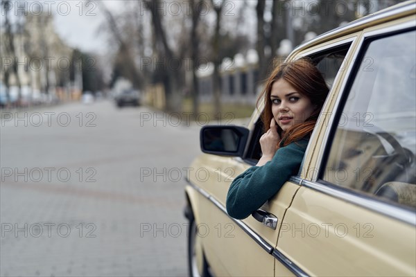 Caucasian woman driving car looking over shoulder