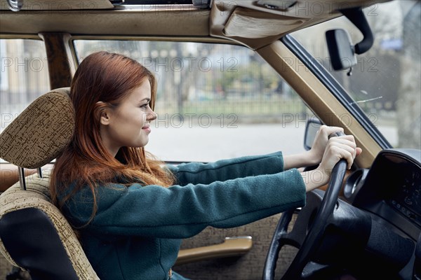 Smiling Caucasian woman driving car