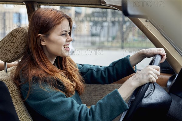 Smiling Caucasian woman driving car