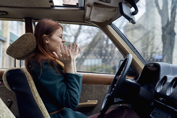 Excited Caucasian woman driving car