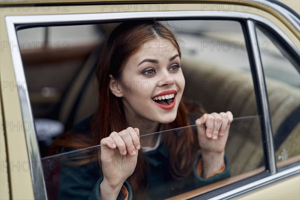 Caucasian woman smiling in back seat of car