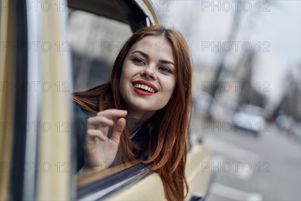 Smiling Caucasian woman in back seat of car