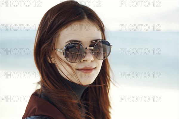 Wind blowing hair of Caucasian woman at beach