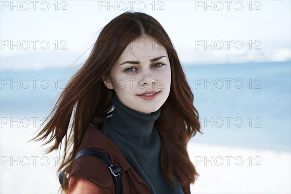 Wind blowing hair of Caucasian woman at beach