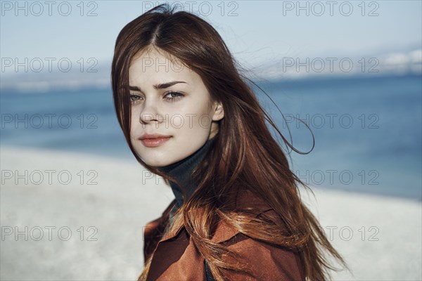 Wind blowing hair of Caucasian woman at beach