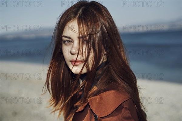 Wind blowing hair of Caucasian woman at beach