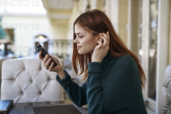 Caucasian woman texting on cell phone at restaurant