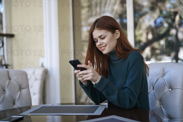 Caucasian woman texting on cell phone at restaurant