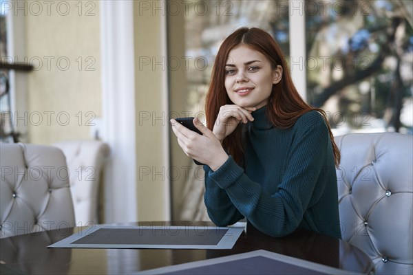 Caucasian woman texting on cell phone at restaurant