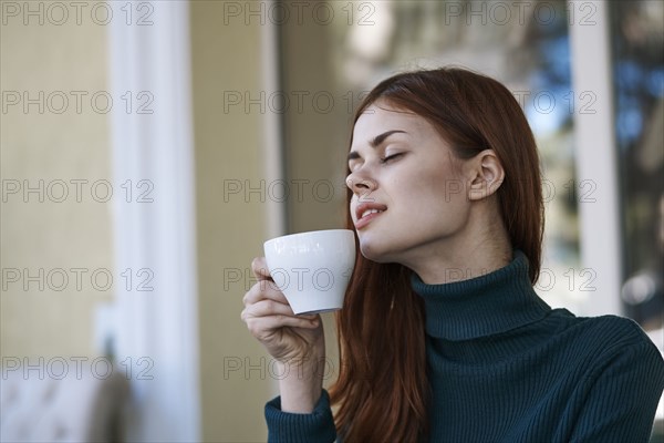 Caucasian woman relaxing and drinking coffee