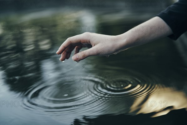 Water dripping from hand of woman