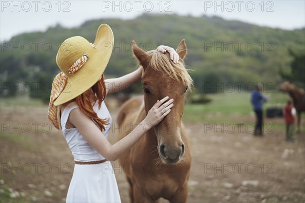 Woman petting horse