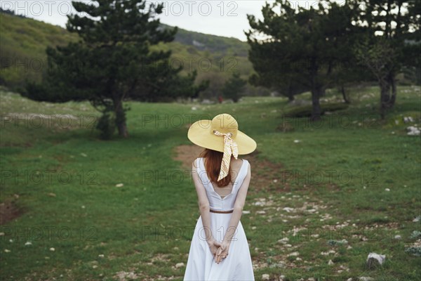 Woman wearing sun hat standing in field