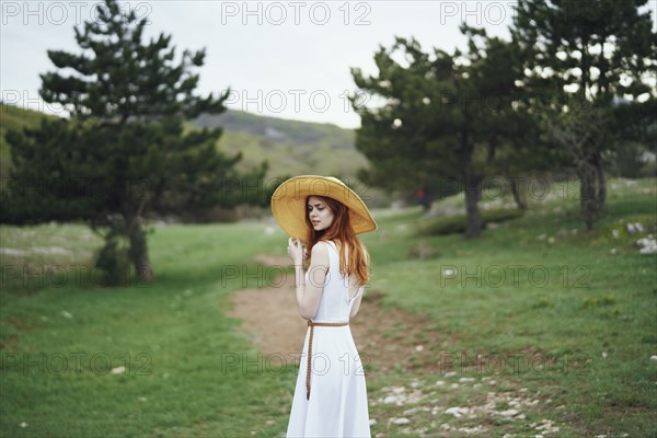 Woman wearing sun hat standing in field