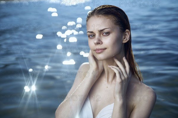 Pensive woman wearing a bikini in ocean