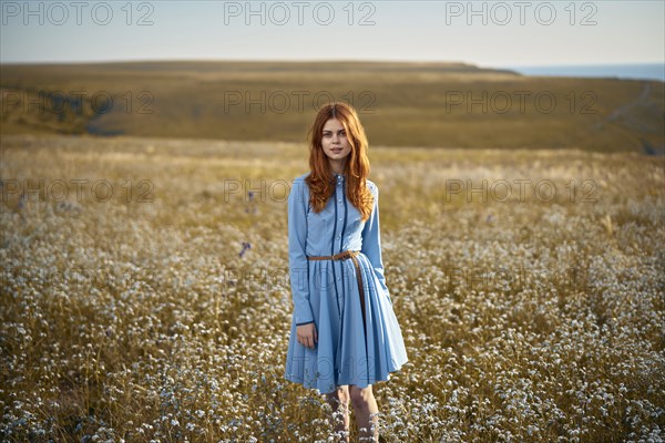 Caucasian woman standing in a field of wildflowers