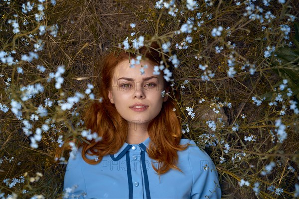 Caucasian woman laying in field of wildflowers