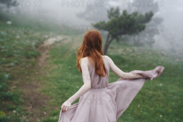 Caucasian woman wearing a dress in field