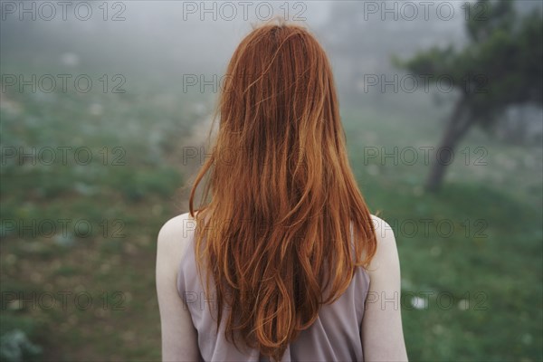 Rear view of Caucasian woman with red hair