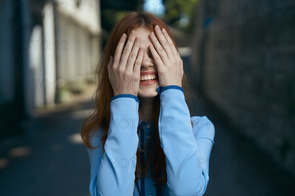 Caucasian woman covering eyes with hands