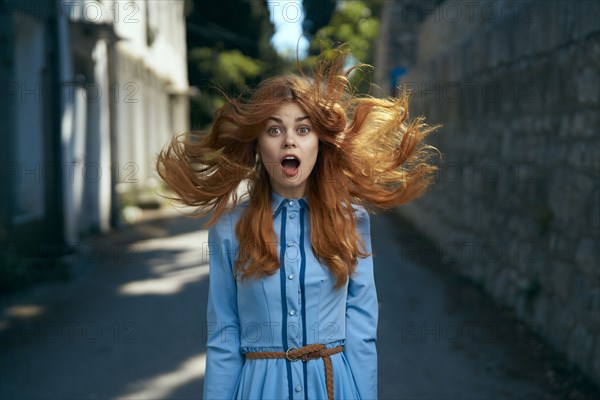 Wind blowing hair of surprised Caucasian woman