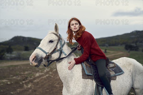 Caucasian woman riding horse