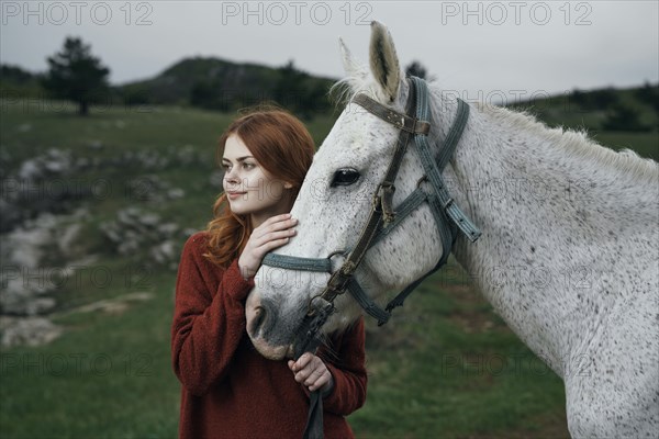 Caucasian woman petting horse